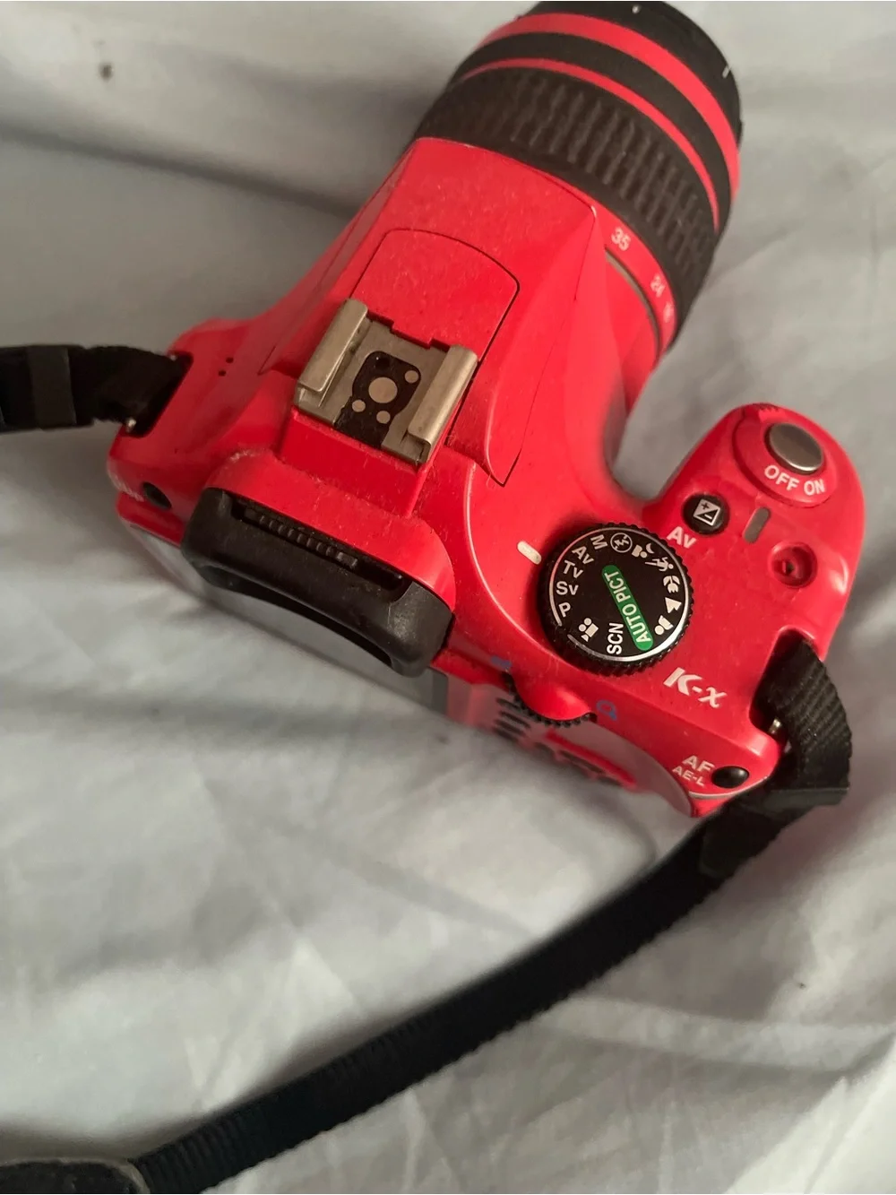 Pentax Red DSLR with Black Strap and 18-55mm Lens